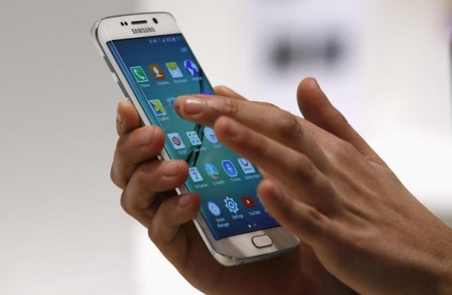 A hostess displays Samsung Galaxy S6 Edge smartphone during the Mobile World Congress