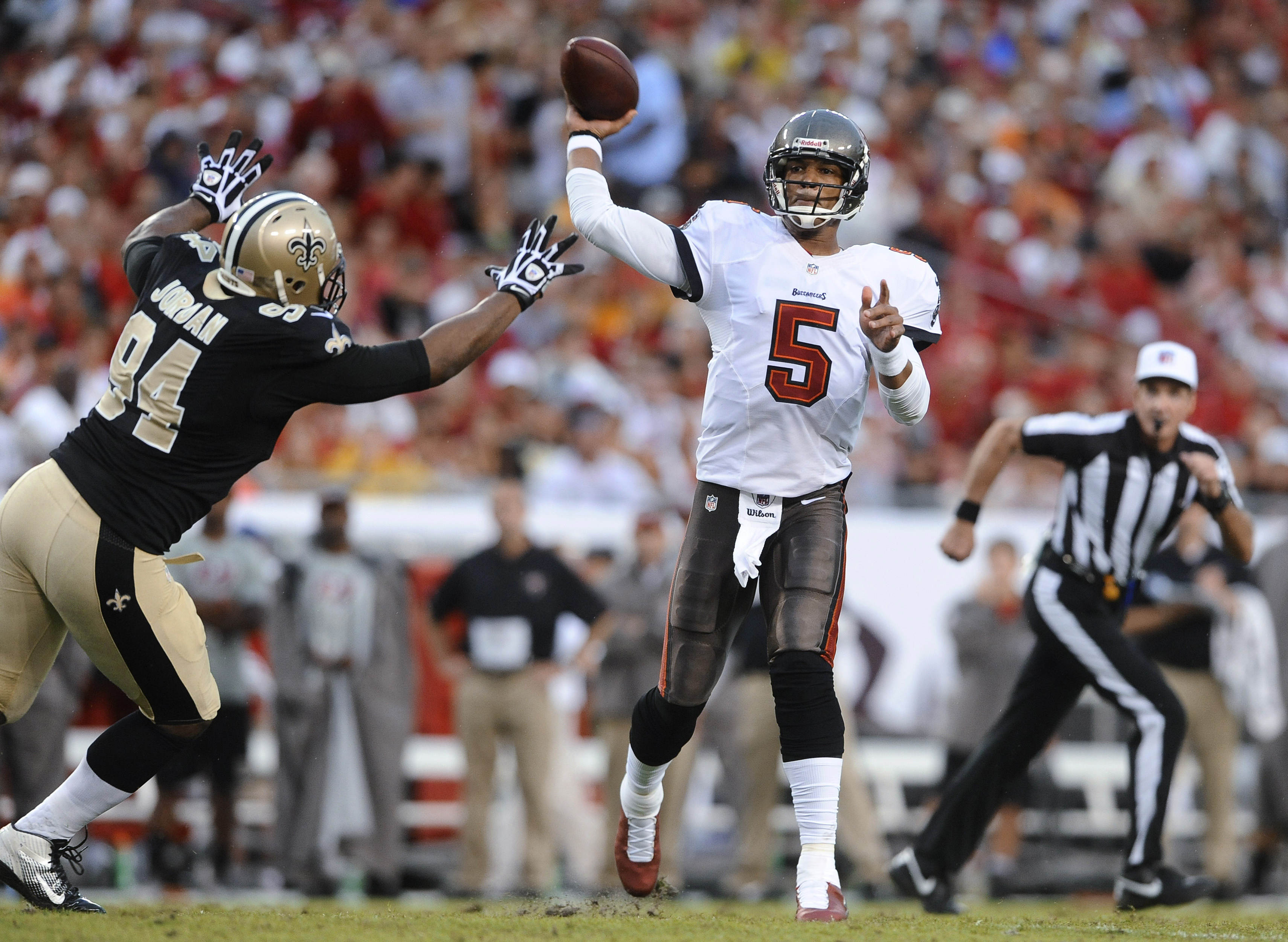 Tampa Bay Buccaneers quarterback Josh Freeman is pressured by New Orleans Saints defensive end Cameron Jordan as he throws a pass during an NFL football game in Tampa Fla. With Indianapolis&#039 top