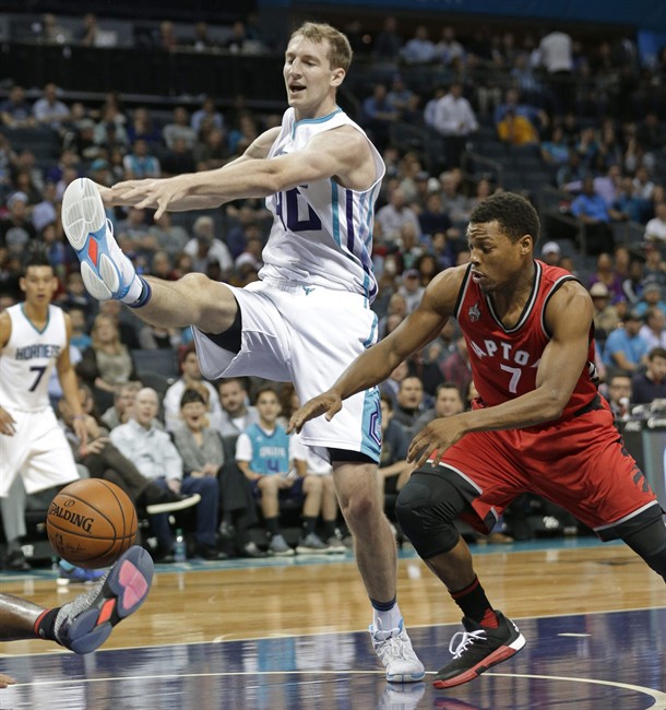 Charlotte Hornets Cody Zeller left and Toronto Raptors Kyle Lowry chase a loose ball during the first half of an NBA basketball game in Charlotte N.C. Thursday Dec. 17 2015