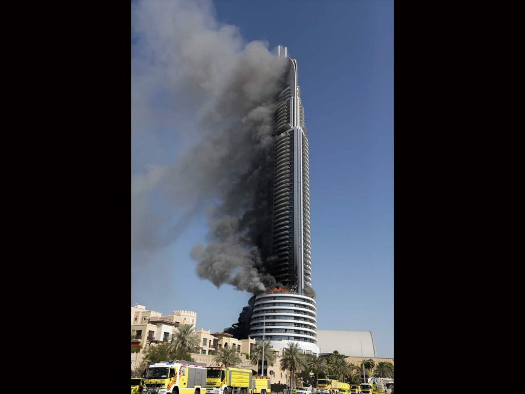 A fire burns on the Address Downtown skyscraper in Dubai United Arab Emirates on Friday Jan. 1 2016