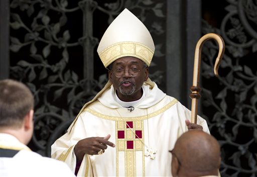 Episcopal Church Presiding Bishop-elect Michael Curry speaks to churchgoers as he arrives at the Washington National Cathedral in Washington. On Thursday Jan. 14 2016 Anglican leaders temporarily restrict