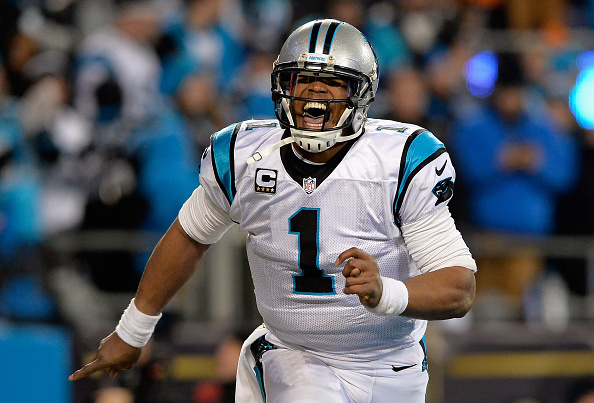 CHARLOTTE NC- JANUARY 24 Cam Newton #1 of the Carolina Panthers celebrates scoring a touchdown in the second quarter against the Arizona Cardinals during the NFC Championship Game at Bank of America Stadium