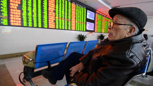 An investor observes stock prices on Jan. 7 2016 in Fuyang China