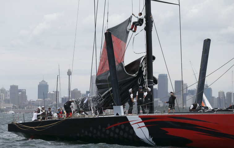 Crew members work Comanche's main mast during preparations for the start of the race on Boxing Day. REUTERS  Jason Reed