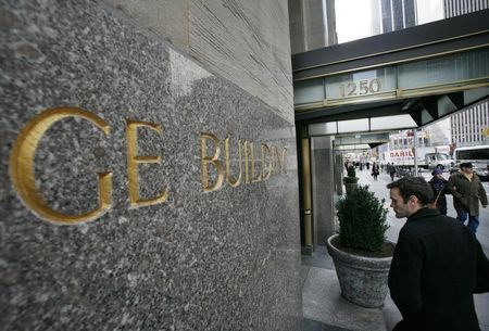 A man enters the General Electric building at 1250 Avenue of the Americas also known as 30 Rockefeller Plaza in New York