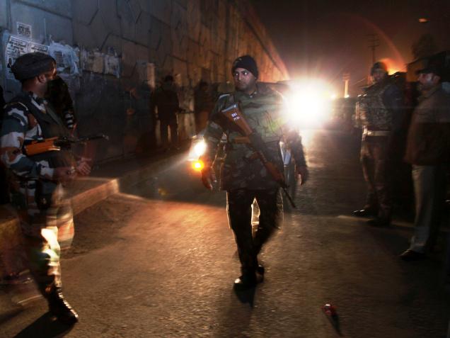 Securitymen stand outside the IAF base in Pathankot which came under militant attack on Saturday