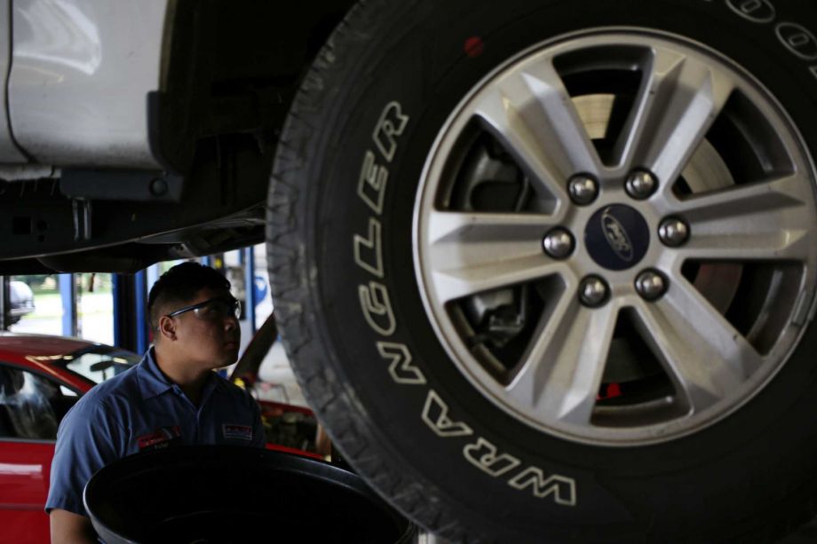 A Pep Boys worker performs an oil change in Clarksville Ind. It appears investor Carl Icahn is the winner in the two-month fight to acquire the chain