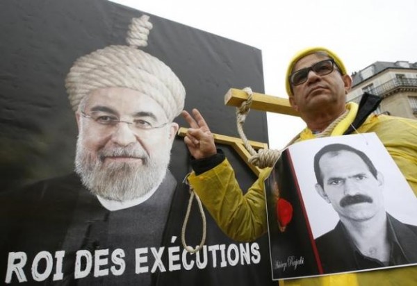 A man takes part in a demonstration against Iran's President Hassan Rouhani visit to France in central Paris France