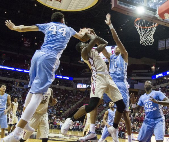 North Carolina forward Justin Jackson left blocks the shot of Florida State guard Dwayne Bacon Jr. center as North Carolina's Brice Johnson right defend in the first half of an NCAA college basketball game in Tallahassee Fla. Monday Jan. 4 201