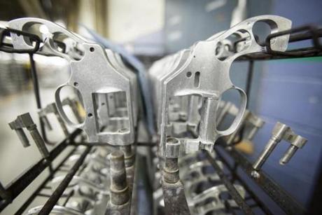 The frames of handguns sat on a rack at the Smith and Wesson factory in Springfield