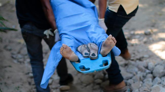 Mexican forensic personnel carry the body of a woman murdered by drug cartel elements