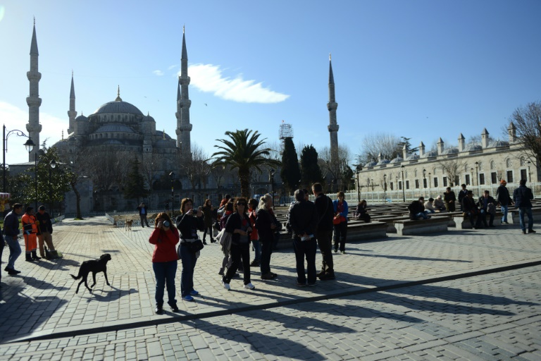 AFP  Ozan Kose Tourists walk past Istanbul's famous Blue Mosque on January 12 a day after a suicide attack killed 10 tourists