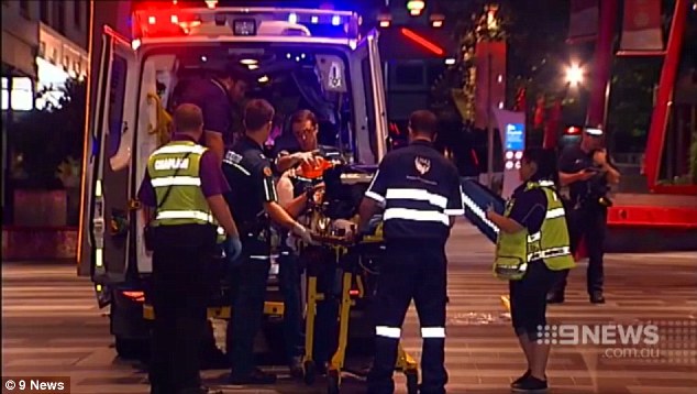 Paramedics attend to the 18-year old man who was coward punched then left for dead on the floor