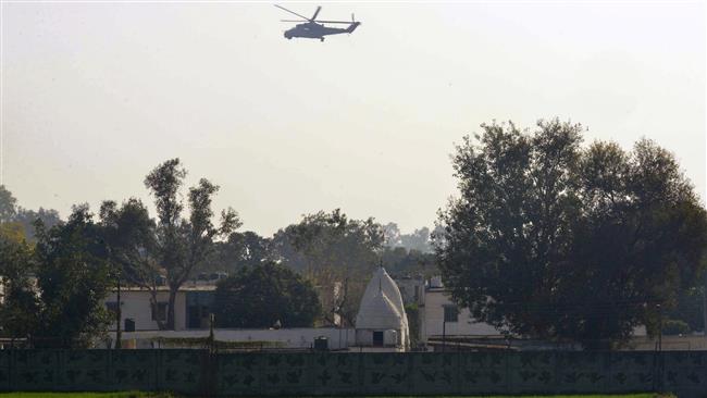 An Indian air force helicopter flies over an airbase in Pathankot Punjab State during an operation to repel an attack by gunmen on the base