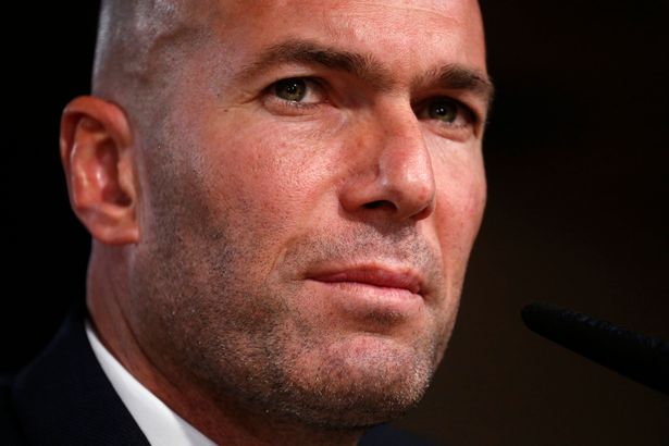 Real Madrid's new coach Zinedine Zidane reacts as he arrives to a news conference at Santiago Bernabeu stadium