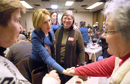 Carly Fiorina shakes hands with people attending a political rally Tuesday at Cronk’s Cafe in Denison. During her campaign stump Fiorina told listeners that on her first day as president she will make two phone calls one to Israel