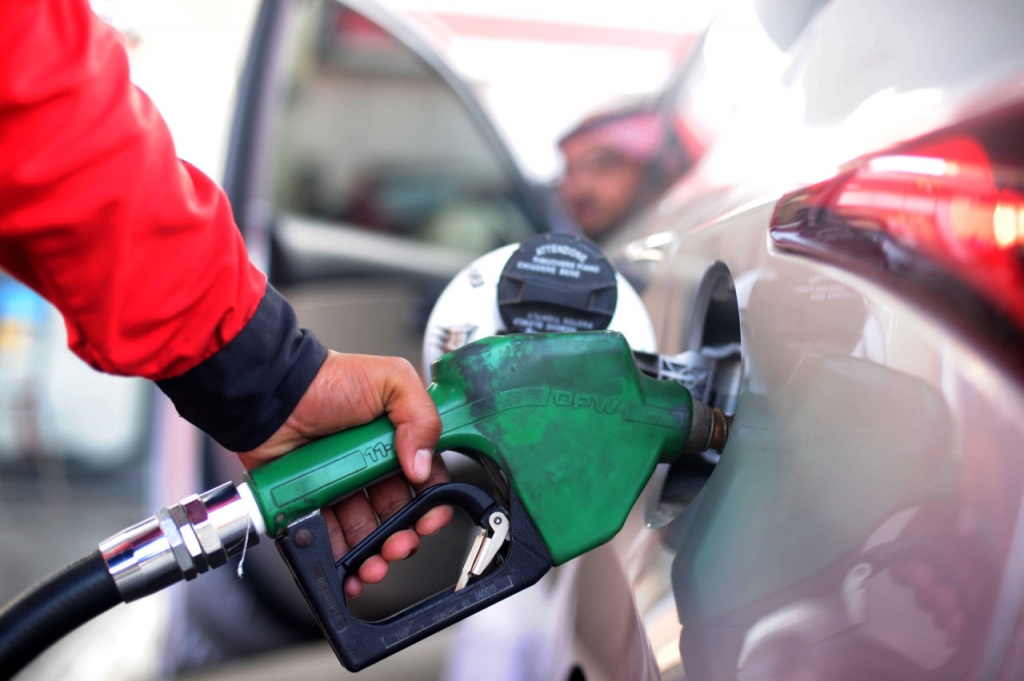 A Saudi employee fills the tank of his car with petrol at a station on December 28 in the Red Sea city of Jeddah. Saudi Arabia said it plans to review the prices of heavily-subsidised power and fuel as part of new measures introduced in the face of low