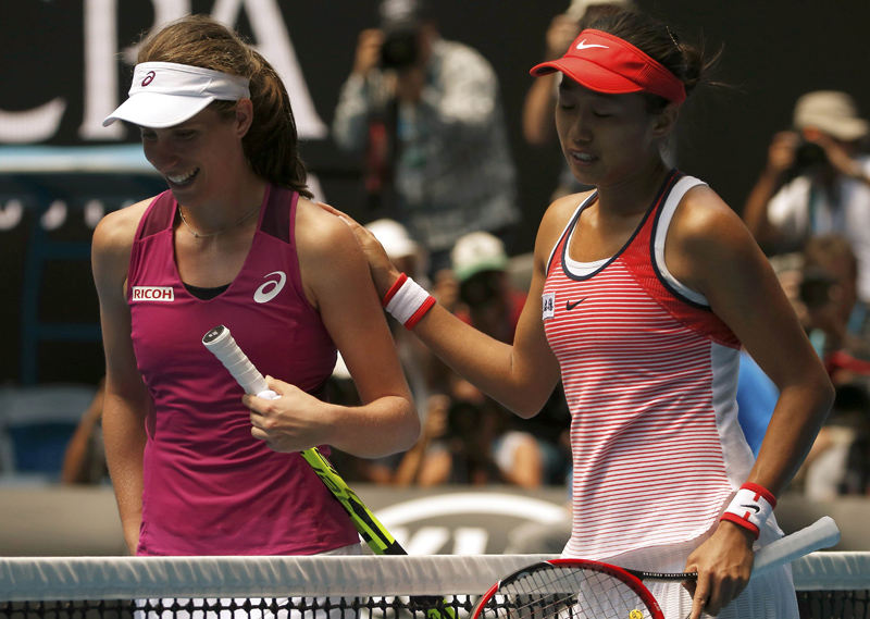 China's Zhang puts her hand on Britain's Konta's shoulder after Konta won their quarter-final match at the Australian Open tennis tournament at Melbourne Park