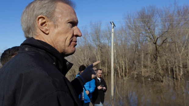 Illinois Gov. Bruce Rauner overlooks the south fork of the Sangamon River where two teenagers were killed while crossing a flooded road last week in Kincaid Ill