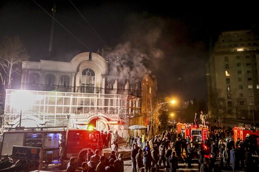 Smoke rises as Iranian protesters set fire to the Saudi embassy in Tehran Sunday Jan. 3 2016. Protesters upset over the execution of a Shiite cleric in Saudi Arabia set fires to the Saudi embassy in Tehran