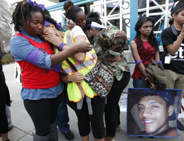 Jakayla Brown comforts a crying friend during a protest over the police shooting of Anthony Hill in Decatur Georgia