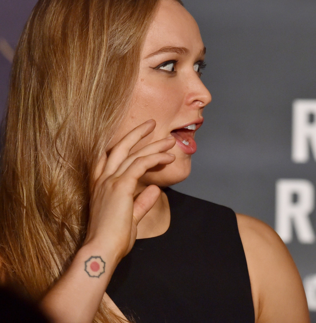 The tattoo on Ronda Rousey’s right wrist matches the tattoo on the unidentified model’s right