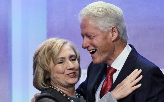 Former Secretary of State Hillary Rodham Clinton is welcomed to the stage by her husband former U.S. President Bill Clinton at the Clinton Global Initiative in a 2014 session