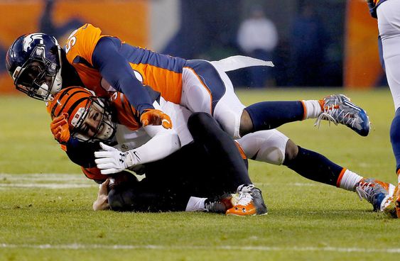 AJ Mc Carron his hit as he slides by Denver Broncos linebacker Shane Ray during the first half of an NFL football game Monday Dec. 28 2015 in Denver