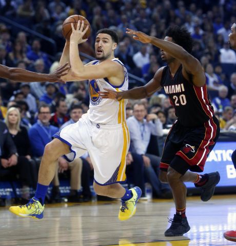 Golden State Warriors Klay Thompson drives past Miami Heat's Justise Winslow in 1st quarter during NBA game at Oracle Arena in Oakland Calif. on Monday