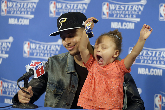 Golden State Warriors guard Stephen Curry is joined by his daughter Riley at a news conference after Game 5 of the N