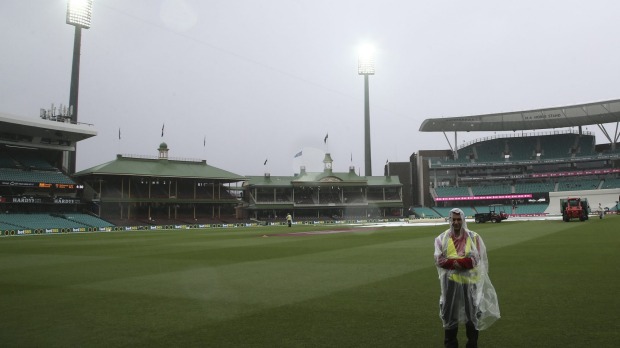 Wet day A security guard stands on the field at the Sydney Cricket Ground as play is abandoned