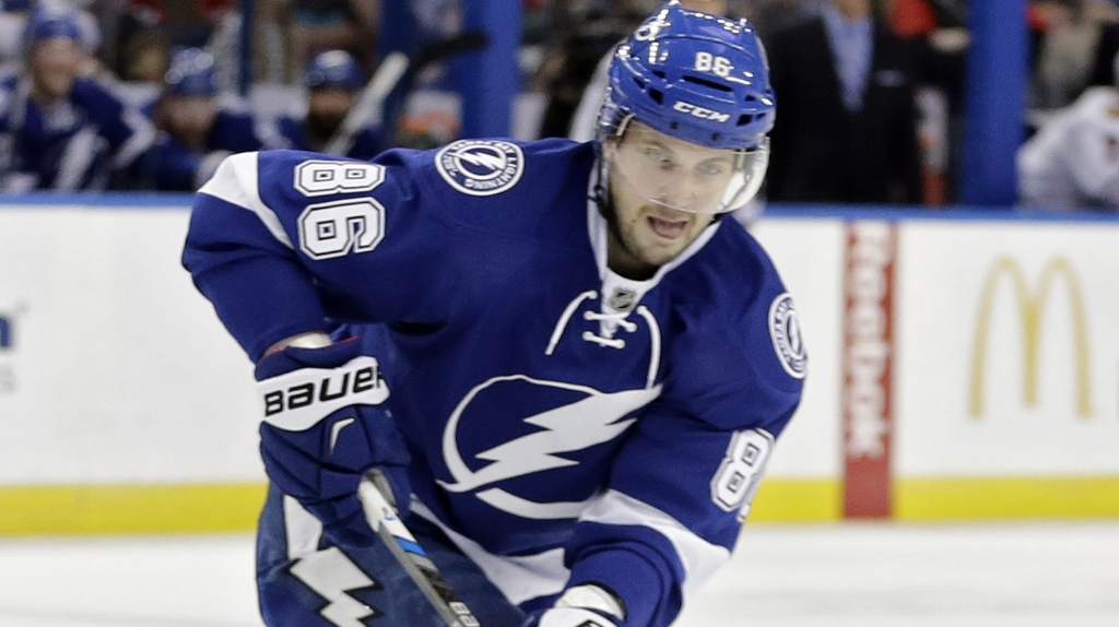 Chicago Blackhawks defenseman Michal Rozsival, of the Czech Republic falls down on the puck in front of Tampa Bay Lightning right wing Nikita Kucherov, of Russia during the second period of an NHL hockey game Thursday Jan. 21 2016 in Tampa