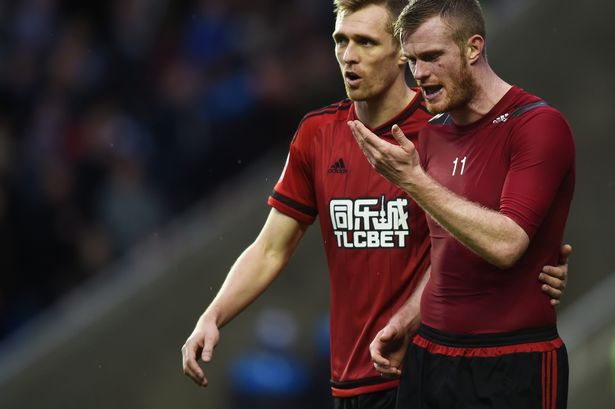 Chris Brunt of West Bromwich Albion leaves the field after being hit by an object