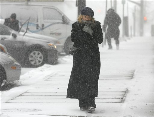 Jean Brown bundles up as she walks in downtown Providence R.I. during a snow storm Monday Feb. 8 2016. Massachusetts Rhode Island and eastern Connecticut could see winter storm conditions with an accumulation of 4 to 8 inches. The heaviest snowfal