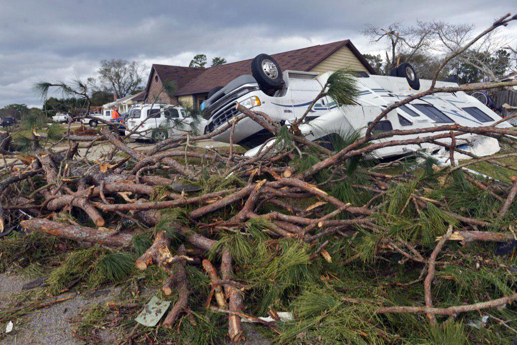 Debris scatters a property in the Northpointe neighborhood in Pensacola Fla. Wednesday after a storm hit the area