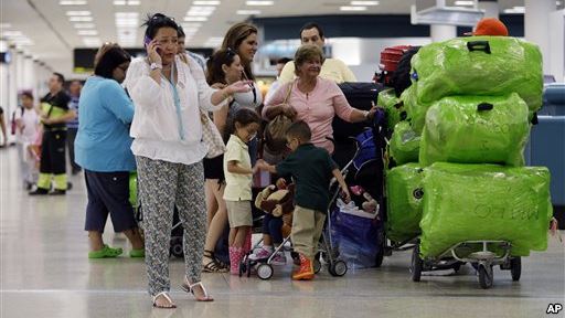 FILE- Passengers wait in line for a flight departing to Cuba at Miami International Airport in Miami Florida Sept. 27 2012