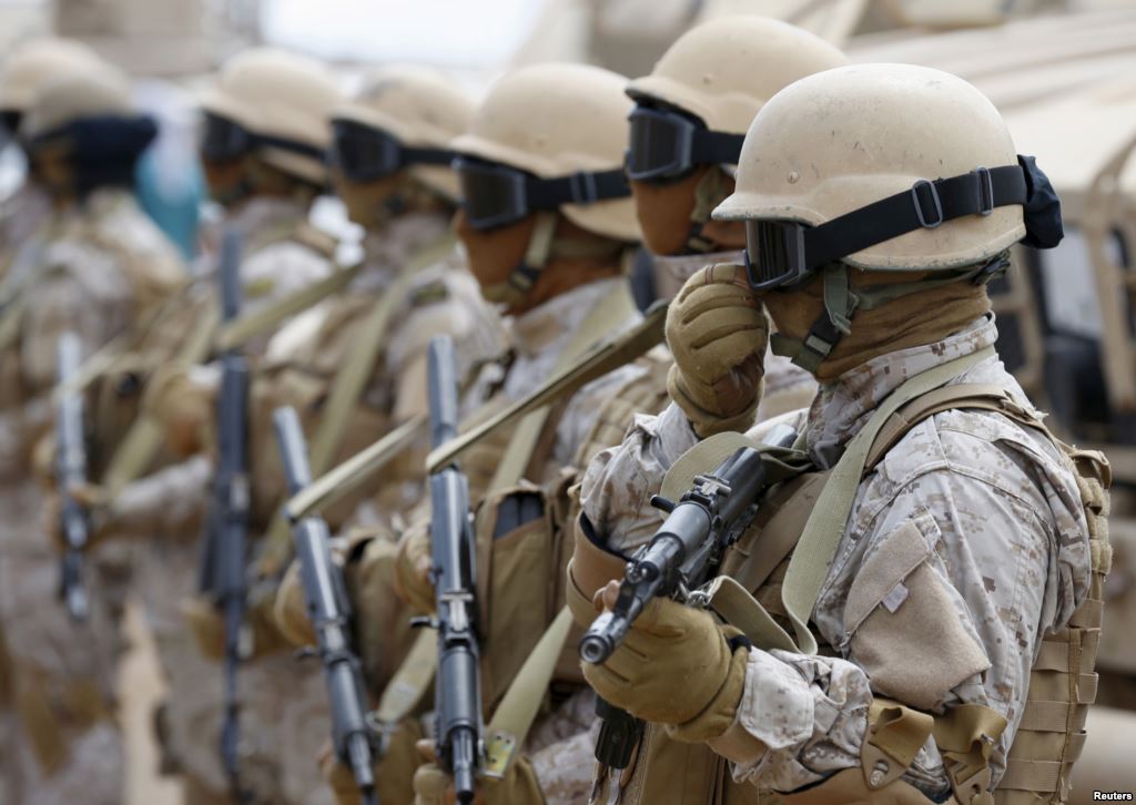 FILE- Saudi troops stand at attention at their base in Yemen's southern port city of Aden Sept. 28 2015