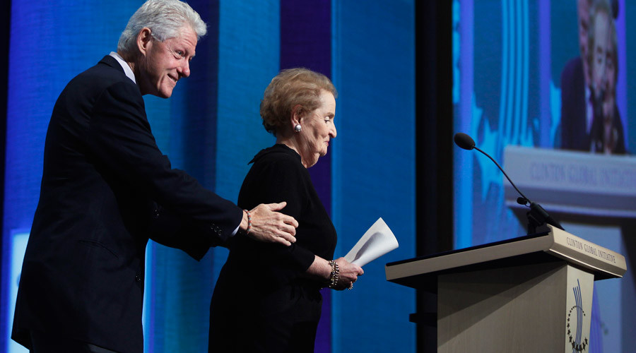 Former U.S. President Bill Clinton assists former U.S. Secretary of State Madeleine Albright at a 2010 event