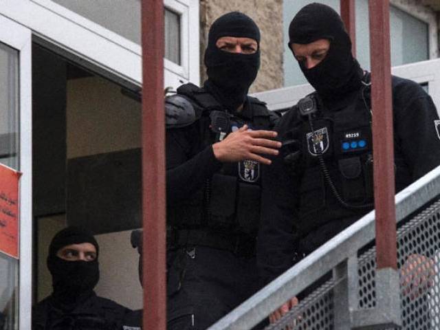 German police stand outside an association linked to a mosque in Berlin's central Tempelhof Schoeneberg district during raid targeting individuals suspected of inciting people to fight for the Islamic State group in Syria