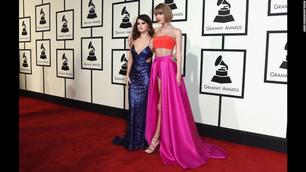 Selena Gomez left and Taylor Swift pose on the red carpet before the 58th Grammy Awards on Monday February 15