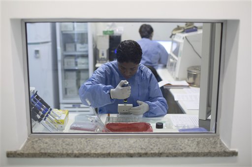 A graduate student works on analyzing samples to identify the Zika virus in a laboratory at the Fiocruz institute in Rio de Janeiro Brazil Friday Jan. 22 2016. Health officials say they're trying to determine if an unusual jump in cases of a rare