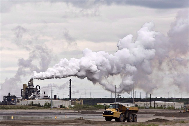 A dump truck works near the Syncrude oil sands extraction facility near the city of Fort McMurray Alta