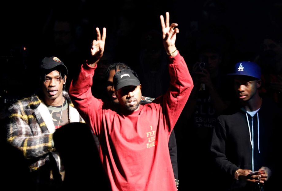 Kanye West gestures to the audience at the unveiling of the Yeezy collection and album release for his latest album'The Life of Pablo' Thursday Feb. 11 2016 at Madison Square Garden in New York