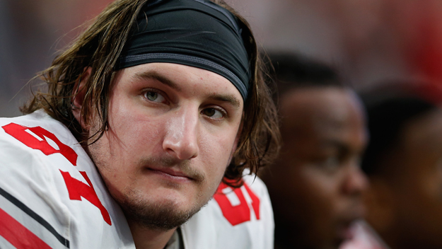 Defensive lineman Joey Bosa #97 of the Ohio State Buckeyes sits on the sideline during the first quarter of the Battle Frog Fiesta Bowl against the Notre Dame Fighting Irish at University of Phoenix Stadium