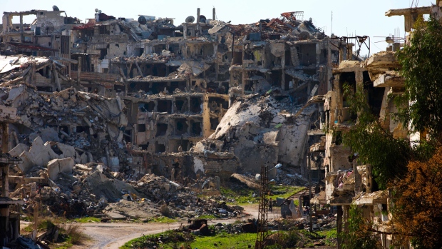 A Syrian man walks through a devastated part of the old city of Homs Syria Friday Feb. 26 2016