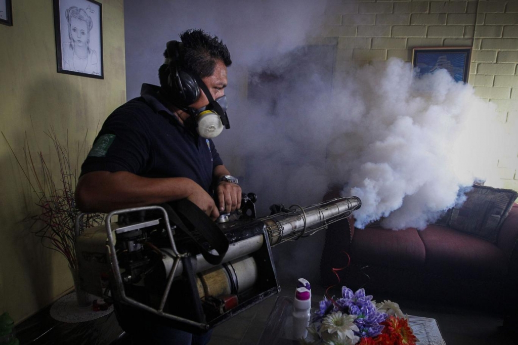 A man fumigates a home in El Salvador