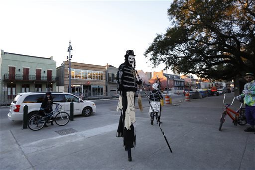 A member of the North Side Skull & Bone Gang dances in front of the Louis Armstrong park during the wake up call for Mardi Gras Tuesday Feb. 9 2016 in New Orleans