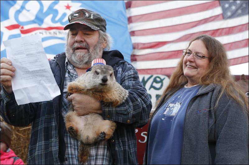 Charlie Hoag left reads Huckey Too's predictions while his wife Terri Hoag right stands nearby during the 16th annual Groundhog Day at the Hoag's residence in Holland today. Huckey Too predicted that there will be 6 weeks until Spring arrives