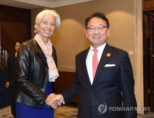 South Korea's Finance Minister Yoo Il-ho shakes hands with International Monetary Fund Managing Director Christine Lagarde in Shanghai on Feb. 27 2016