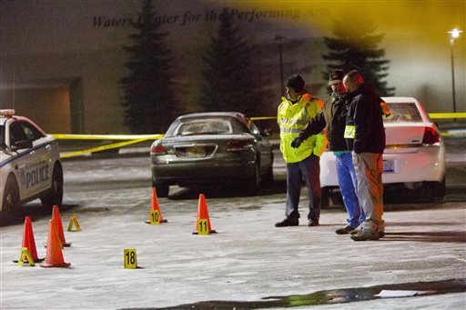 Officials investigate shooting scenes in the parking lot of Muskegon Heights High School in Muskegon Heights Mich. Tuesday Feb. 9 2016. The shootings happened around 9:30 p.m. after a basketball game at the high school. (Joel Bissell  MLive-Muskegon Ch